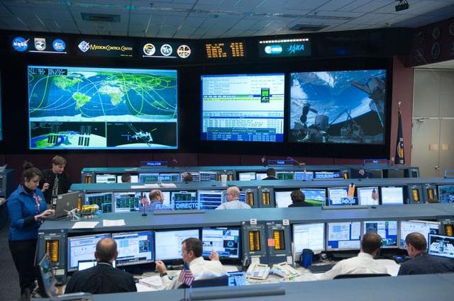 NASA image: STS-133/ULF5 Orbit 1 flight controllers on console during unberth of Permanent Multipurpose Module (PMM) from shuttle.   