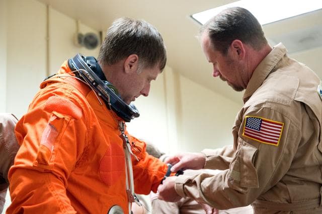 NASA image: STS-135 Crew during prep and insertion into Fixed Base Simulator     