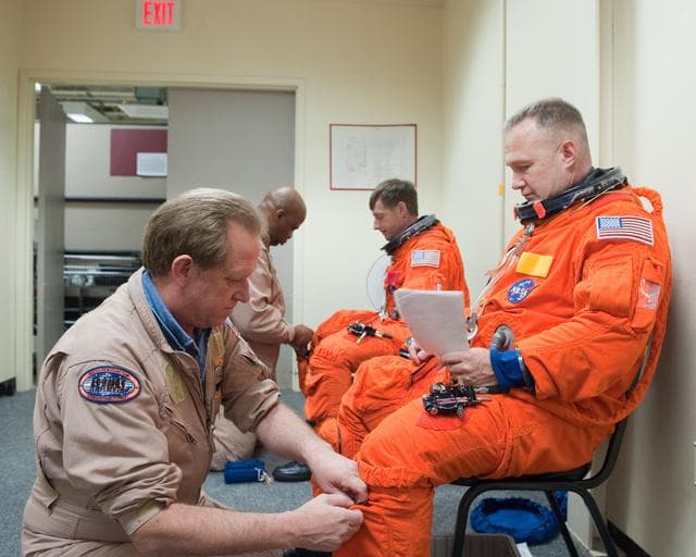 NASA image: STS-135 Crew during prep and insertion into Fixed Base Simulator     