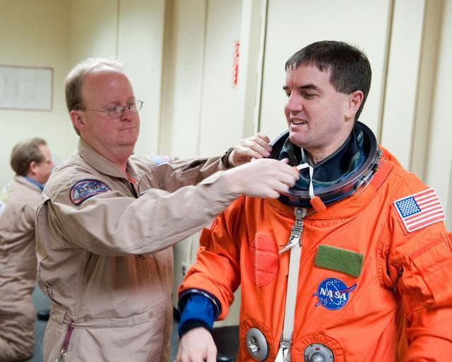 NASA image: STS-135 Crew during prep and insertion into Fixed Base Simulator     