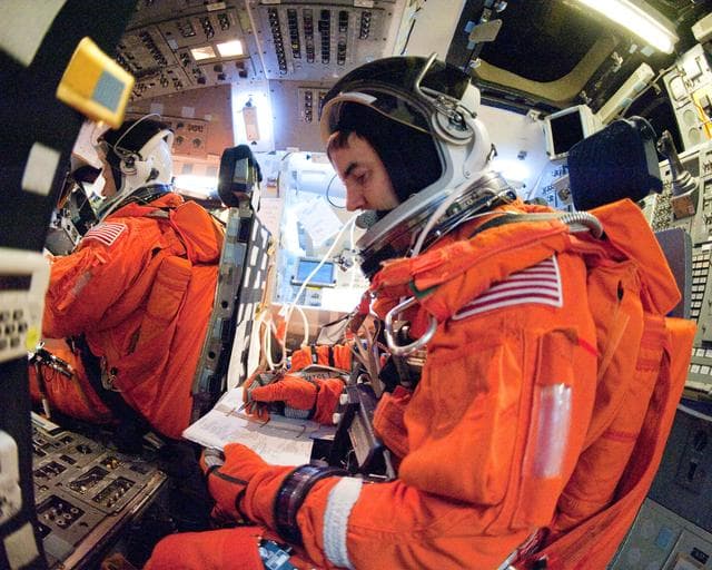 NASA image: STS-135 Crew during prep and insertion into Fixed Base Simulator     
