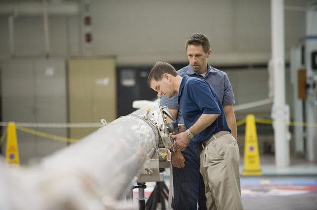 NASA image: STS-135 crew members Rex Walheim and Sandra Magnus during EVA TPS OPS at 1G Trainer at the NBL.
