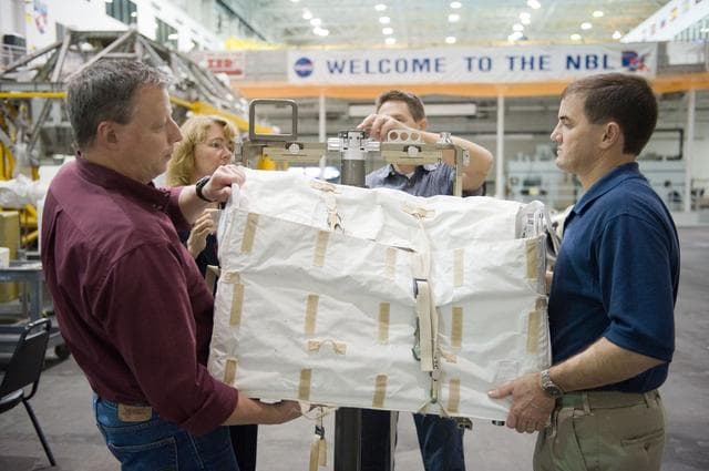NASA image: STS-135 crew members Rex Walheim and Sandra Magnus during EVA TPS OPS at 1G Trainer at the NBL.