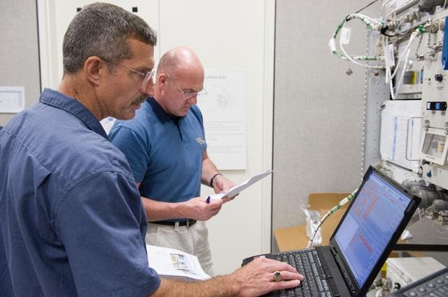 NASA image: Expedition 29 crew members Dan Burbank and Andre Kuipers working with ALTEA Dosi training.