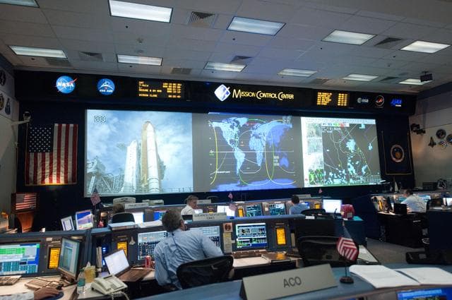 NASA image: STS135 flight controllers on console during last shuttle mission