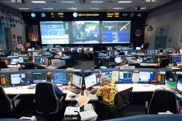 NASA image: STS-135 Flight Controllers on Console. Orbit 3