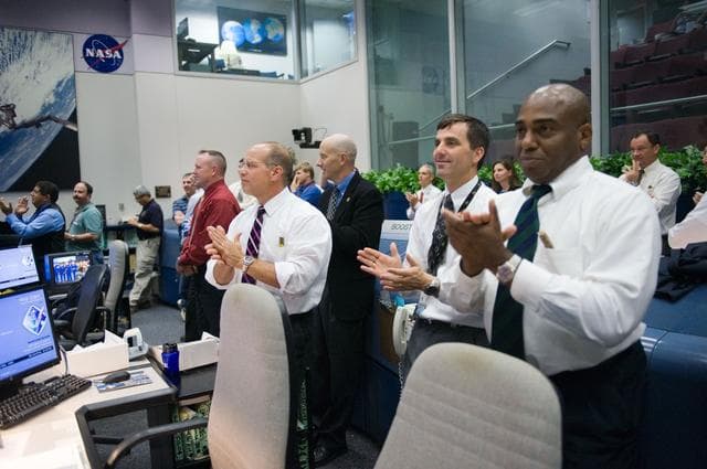 NASA image: STS-135 entry flight controllers on console
