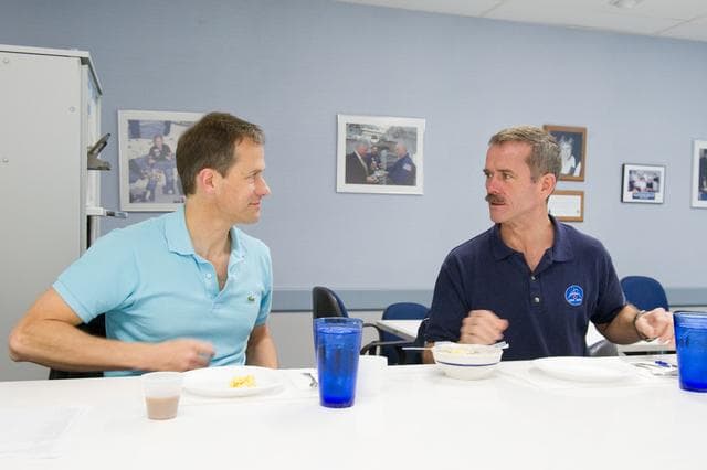 NASA image: Expedition 34 Soyuz crew Tom Marshburn and Chris Hadfield during their food tasting