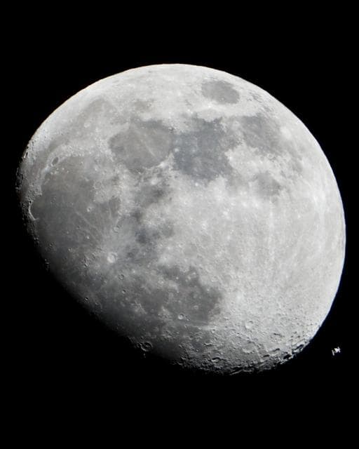 NASA image: The International Space Station can be seen as a small object in lower right of this image of the moon