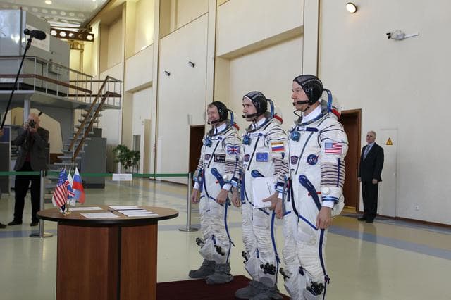 NASA image: CG4G8713 --- (6 May 2015) --- At the Gagarin Cosmonaut Training Center in Star City, Russia, Expedition 44/45 backup Soyuz Commander Yuri Malenchenko of the Russian Federal Space Agency (Roscosmos, center) and his crewmates, Timothy Peake of the European Space Agency (left) and Timothy Kopra of NASA (right),  prepare to sign in for the first of two days of qualification exams. They are the backups to the prime crew --- Kjell Lindgren of NASA, Oleg Kononenko of Roscosmos and Kimya Yui of the Japan Aerospace Exploration Agency --- who are in the final stages of training for launch May 27, Kazakh time, in the Soyuz TMA-17M spacecraft to begin a five and a half month mission to the International Space Station. Photo credit: NASA/Seth Marcantel