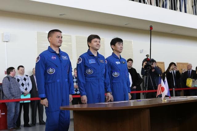 NASA image: CG4G8889 --- (6 May 2015) --- At the Gagarin Cosmonaut Training Center in Star City, Russia, Expedition 44/45 crewmembers Kjell Lindgren of NASA (left), Oleg Kononenko of the Russian Federal Space Agency (Roscosmos, center), and Kimya Yui of the Japan Aerospace Exploration Agency (right) appear before Russian space officials on the first of two days of qualification exams May 6. The trio is preparing for launch from the Baikonur Cosmodrome in Kazakhstan on May 27, Kazakh time, in the Soyuz TMA-17M spacecraft to begin a five and a half month mission to the International Space Station. Photo credit: NASA/Seth Marcantel
