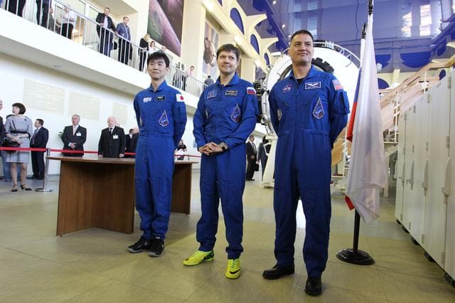 NASA image: CG4G9036 --- (6 May 2015) --- At the Gagarin Cosmonaut Training Center in Star City, Russia, Expedition 44/45 crewmembers Kimya Yui of the Japan Aerospace Exploration Agency (left), Oleg Kononenko of the Russian Federal Space Agency (Roscosmos, center), and Kjell Lindgren of NASA (right) answer questions from media on the first of two days of qualification exams May 6. The trio is preparing for launch from the Baikonur Cosmodrome in Kazakhstan on May 27, Kazakh time, in the Soyuz TMA-17M spacecraft to begin a five and a half month mission to the International Space Station. Photo credit: NASA/Seth Marcantel