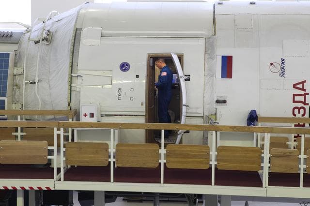 NASA image: CG4G9159 --- (6 May 2015) --- At the Gagarin Cosmonaut Training Center in Star City, Russia, Expedition 44/45 Flight Engineer Kjell Lindgren of NASA joins his crewmates, Oleg Kononenko of the Russian Federal Space Agency (Roscosmos) and Kimya Yui of the Japan Aerospace Exploration Agency (not pictured), in the International Space Station Zvezda Service Module training mockup on the first of two days of qualification exams May 6. The trio is preparing for launch from the Baikonur Cosmodrome in Kazakhstan on May 27, Kazakh time, in the Soyuz TMA-17M spacecraft to begin a five and a half month mission to the International Space Station. Photo credit: NASA/Seth Marcantel..