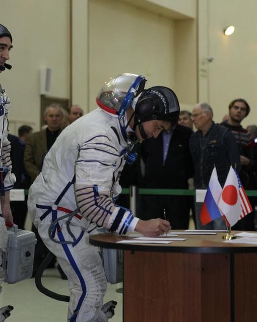 NASA image: At the Gagarin Cosmonaut Training Center in Star City, Russia, Expedition 46-47 backup crewmember Takuya Onishi of the Japan Aerospace Exploration Agency signs in Nov. 19 for the start of qualification exams. Onishi as his crewmates, Kate Rubins of NASA and Anatoly Ivanishin of the Russian Federal Space Agency (Roscosmos) are the backups to the prime crewmembers, Yuri Malenchenko of Roscosmos, Tim Kopra of NASA and Tim Peake of the European Space Agency, who will launch Dec. 15 in the Soyuz TMA-19M spacecraft from the Baikonur Cosmodrome in Kazakhstan for a six-month mission on the International Space Station..NASA/Seth Marcantel