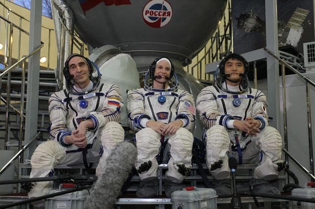 NASA image: At the Gagarin Cosmonaut Training Center in Star City, Russia, Expedition 46-47 backup crewmembers Anatoly Ivanishin of the Russian Federal Space Agency (Roscosmos, left), Kate Rubins of NASA (center) and Takuya Onishi of the Japan Aerospace Exploration Agency (right) listen to reporters��� questions in front of a Soyuz simulator Nov. 19 at the start of qualification exams. They are the backups to the prime crewmembers, Yuri Malenchenko of Roscosmos, Tim Kopra of NASA and Tim Peake of the European Space Agency, who will launch Dec. 15 in the Soyuz TMA-19M spacecraft from the Baikonur Cosmodrome in Kazakhstan for a six-month mission on the International Space Station..NASA/Seth Marcantel