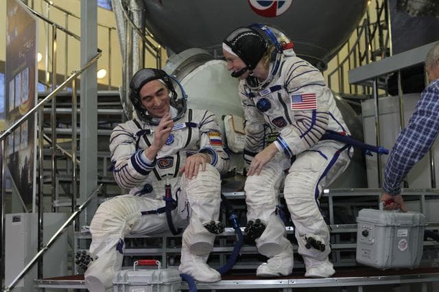 NASA image: At the Gagarin Cosmonaut Training Center in Star City, Russia, Expedition 46-47 backup crewmembers Anatoly Ivanishin of the Russian Federal Space Agency (Roscosmos, left) and Kate Rubins of NASA prepare to enter a Soyuz simulator Nov. 19 at the start of qualification exams. Along with Takuya Onishi of the Japan Aerospace Exploration Agency, they are the backups to the prime crewmembers, Yuri Malenchenko of Roscosmos, Tim Kopra of NASA and Tim Peake of the European Space Agency, who will launch Dec. 15 in the Soyuz TMA-19M spacecraft from the Baikonur Cosmodrome in Kazakhstan for a six-month mission on the International Space Station..NASA/Seth Marcantel