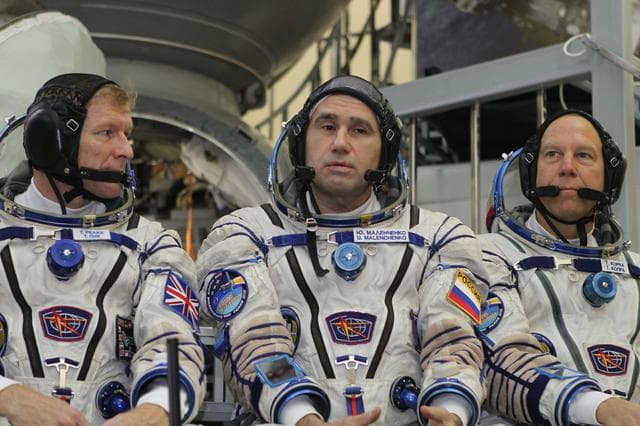 NASA image: At the Gagarin Cosmonaut Training Center in Star City, Russia, Expedition 46-47 crewmember Yuri Malenchenko of the Russian Federal Space Agency (Roscosmos) responds to a reporter���s question Nov. 20 during final qualification exams. Looking on are crewmates Tim Peake of the European Space Agency (left) and Tim Kopra of NASA (right). The trio will launch Dec. 15 on their Soyuz TMA-19M spacecraft Dec. 15 from the Baikonur Cosmodrome in Kazakhstan for a six-month mission on the International Space Station..NASA/Seth Marcantel
