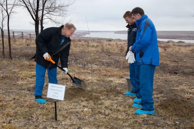 NASA image: Behind the Cosmonaut Hotel crew quarters in Baikonur, Kazakhstan, Expedition 46-47 crewmember Tim Kopra of NASA (left) plants a tree at a site bearing his name Dec. 9 in a traditional pre-launch ceremony. Looking on are his crewmates, Tim Peake of the European Space Agency (center) and Yuri Malenchenko of the Russian Federal Space Agency (Roscosmos, right).  The trio will launch Dec. 15 on their Soyuz TMA-19M spacecraft for a six-month mission on the International Space Station...NASA/Victor Zelentsov.