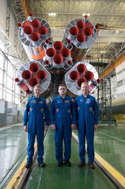 NASA image: In the Integration Facility at the Baikonur Cosmodrome in Kazakhstan, Expedition 46-47 crewmembers Tim Peake of the European Space Agency (left), Yuri Malenchenko of the Russian Federal Space Agency (Roscosmos, center) and Tim Kopra of NASA (right) posed for pictures Dec. 10 in front of the first stage of the Soyuz booster rocket during final pre-launch training. Kopra, Peake and Malenchenko will launch Dec. 15 on the Soyuz TMA-19M spacecraft for a six-month mission on the International Space Station...NASA/Victor Zelentsov.