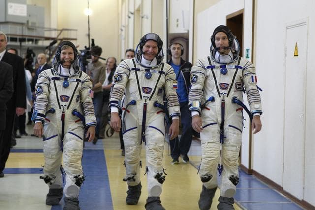 NASA image: At the Gagarin Cosmonaut Training Center in Star City, Russia, Expedition 48-49 backup crewmembers Peggy Whitson of NASA (left), Oleg Novitskiy of Roscosmos (center) and Thomas Pesquet of the European Space Agency (right) arrive for Soyuz qualification exams May 26. They are serving as the backups to prime crewmembers Kate Rubins of NASA, Takuya Onishi of the Japan Aerospace Exploration Agency and Anatoly Ivanishin of Roscosmos, who will launch June 24 on the Soyuz MS-01 spacecraft from the Baikonur Cosmodrome in Kazakhstan for a four-month mission on the International Space Station...NASA/Stephanie Stoll.