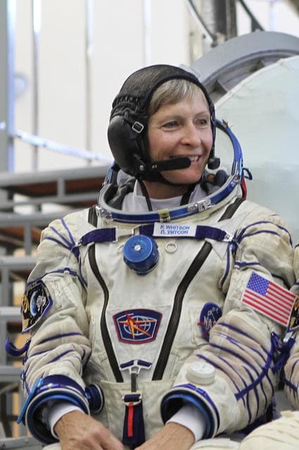 NASA image: At the Gagarin Cosmonaut Training Center in Star City, Russia, Expedition 48-49 backup crewmember Peggy Whitson of NASA flashes a smile in front of a Soyuz simulator May 26 during final qualification exams. Whitson, Thomas Pesquet of the European Space Agency and Oleg Novitskiy of Roscosmos are serving as the backups to prime crewmembers Kate Rubins of NASA, Takuya Onishi of the Japan Aerospace Exploration Agency and Anatoly Ivanishin of Roscosmos, who will launch June 24 on the Soyuz MS-01 spacecraft from the Baikonur Cosmodrome in Kazakhstan for a four-month mission on the International Space Station...NASA/Stephanie Stoll.