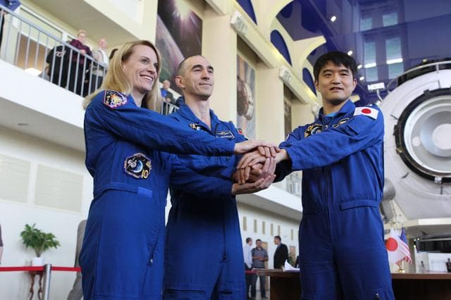 NASA image: At the Gagarin Cosmonaut Training Center in Star City, Russia, Expedition 48-49 prime crewmembers Kate Rubins of NASA (left), Anatoly Ivanishin of Roscosmos (center) and Takuya Onishi of the Japan Aerospace Exploration Agency (right) pose for pictures May 26 during a final qualification exam session. Rubins, Onishi and Ivanishin will launch June 24 on the Soyuz MS-01 spacecraft from the Baikonur Cosmodrome in Kazakhstan for a four-month mission on the International Space Station...NASA/Stephanie Stoll.