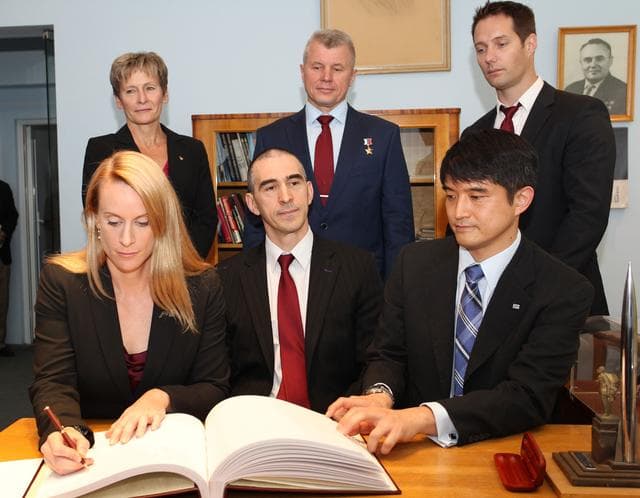 NASA image: At the Gagarin Cosmonaut Training Center in Star City, Russia, Expedition 48-49 crewmember Kate Rubins of NASA (front row, left) signs a commemorative book May 31 following the crew���s news conference. Looking on are crewmates Anatoly Ivanishin of Roscosmos (front row, center) and Takuya Onishi of the Japan Aerospace Exploration Agency (front row, right). In the back row from left to right are backup crewmembers Peggy Whitson of NASA (left), Oleg Novitskiy of Roscosmos (center) and Thomas Pesquet of the European Space Agency (right). Rubins, Ivanishin and Onishi are scheduled to launch June 24 from the Baikonur Cosmodrome in Kazakhstan on the Soyuz MS-01 spacecraft for a four-month mission on the International Space Station...NASA/Stephanie Stoll.