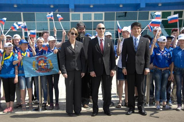 NASA image: ISS Expedition 48-49 prime crewmembers Kate Rubins of NASA (left), Anatoly Ivanishin of Roscosmos (center) and Takuya Onishi of the Japan Aerospace Exploration Agency (right) pose for pictures with schoolchildren after arriving in Baikonur, Kazakhstan June 24 for final pre-launch training following a flight from Star City, Russia. The trio will launch July 7 from the Baikonur Cosmodrome in Kazakhstan on the Soyuz MS-01 spacecraft for a planned four-month mission on the International Space Station...NASA/Alexander Vysotsky.