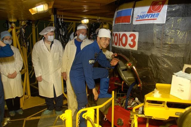NASA image: In the Integration Facility at the Baikonur Cosmodrome in Kazakhstan, Expedition 48-49 crewmember Takuya Onishi of the Japan Aerospace Exploration Agency climbs aboard the Soyuz MS-01 spacecraft June 25 for a �ޔfit check��� dress rehearsal activity. Onishi, Kate Rubins of NASA and Anatoly Ivanishin of Roscosmos will launch on July 7, Baikonur time, on the Soyuz MS-01 for a planned four-month mission on the International Space Station...NASA/Alexander Vysotsky.