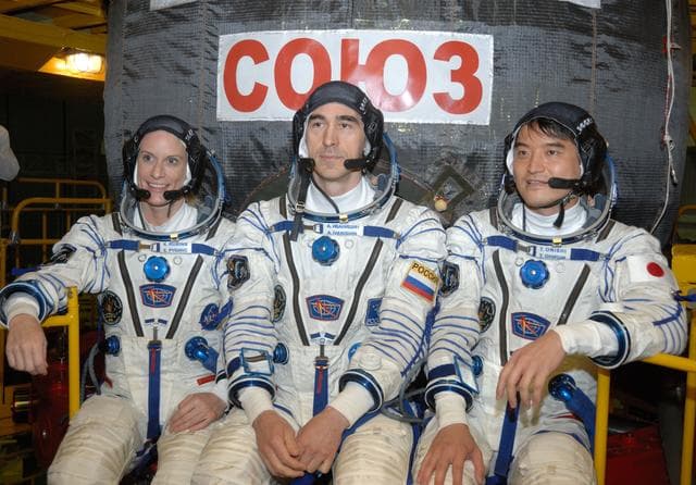NASA image: In the Integration Facility at the Baikonur Cosmodrome in Kazakhstan, Expedition 48-49 crewmembers Kate Rubins of NASA (left), Anatoly Ivanishin of Roscosmos (center) and Takuya Onishi of the Japan Aerospace Exploration Agency (right) pose for pictures June 25 in front of the Soyuz MS-01 spacecraft during a �ޔfit check��� dress rehearsal activity. The trio will launch on July 7, Baikonur time, on the Soyuz MS-01 for a planned four-month mission on the International Space Station...NASA/Alexander Vysotsky.