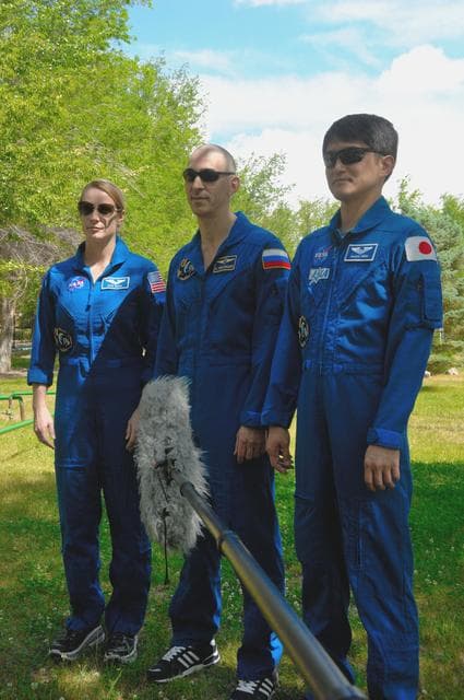 NASA image: Outside their Cosmonaut Hotel crew quarters in Baikonur, Kazakhstan, Kate Rubins of NASA (left), Anatoly Ivanishin of Roscosmos (center) and Takuya Onishi of the Japan Aerospace Exploration Agency (right) answer reporters��� questions June 26 as they continue preparations for launch on July 7, Baikonur time, on the Soyuz MS-01 spacecraft for a planned four-month mission on the International Space Station...NASA/Alexander Vysotsky.