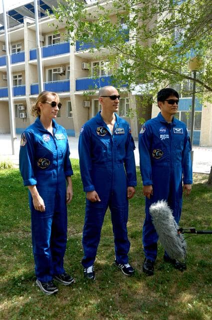 NASA image: Outside their Cosmonaut Hotel crew quarters in Baikonur, Kazakhstan, Kate Rubins of NASA (left), Anatoly Ivanishin of Roscosmos (center) and Takuya Onishi of the Japan Aerospace Exploration Agency (right) answer reporters��� questions June 26 as they continue preparations for launch on July 7, Baikonur time, on the Soyuz MS-01 spacecraft for a planned four-month mission on the International Space Station...NASA/Alexander Vysotsky.