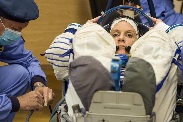 NASA image: In the Integration Facility at the Baikonur Cosmodrome in Kazakhstan, Expedition 48-49 crewmember Kate Rubins of NASA conducts a leak check of her Russian Sokol launch and entry suit June 25 as part of the preparations for launch with Anatoly Ivanishin of Roscosmos and Takuya Onishi of the Japan Aerospace Exploration Agency on July 7, Baikonur time, on the Soyuz MS-01 spacecraft for a planned four-month mission on the International Space Station...GCTC/Andrei Shelepin.