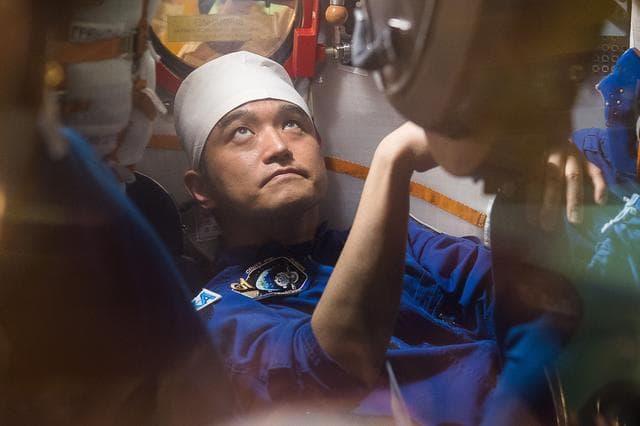 NASA image: In the Integration Facility at the Baikonur Cosmodrome in Kazakhstan, Expedition 48-49 crewmember Takuya Onishi of the Japan Aerospace Exploration Agency conducts a �ޔfit check��� familiarization aboard the Soyuz MS-01 spacecraft June 25 as part of the preparations for launch with Anatoly Ivanishin of Roscosmos and Kate Rubins of NASA on July 7, Baikonur time for a planned four-month mission on the International Space Station...GCTC/Andrei Shelepin.