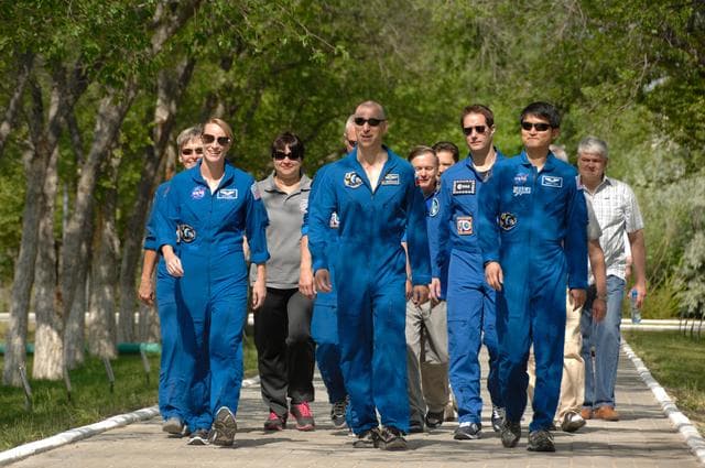 NASA image: At the Cosmonaut Hotel in Baikonur, Kazakhstan, Expedition 48-49 crewmembers Kate Rubins of NASA (left), Anatoly Ivanishin of Roscosmos (center) and Takuya Onishi of the Japan Aerospace Exploration Agency (right) take a stroll down the �ޔWalk of Cosmonauts��� June 30 as part of their pre-launch activities. Rubins, Ivanishin and Onishi will launch July 7, Baikonur time, on the Soyuz MS-01 spacecraft for a planned four-month mission on the International Space Station...NASA/Alexander Vysotsky.