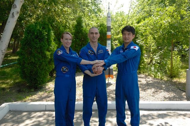 NASA image: At the Cosmonaut Hotel in Baikonur, Kazakhstan, Expedition 48-49 crewmembers Kate Rubins of NASA (left), Anatoly Ivanishin of Roscosmos (center) and Takuya Onishi of the Japan Aerospace Exploration Agency (right) pose for pictures June 30 during traditional pre-launch activities. Rubins, Ivanishin and Onishi will launch July 7, Baikonur time, on the Soyuz MS-01 spacecraft for a planned four-month mission on the International Space Station...NASA/Alexander Vysotsky.