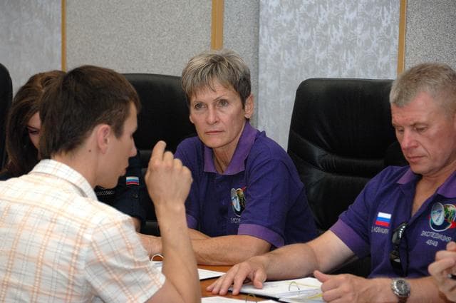 NASA image: At the Cosmonaut Hotel in Baikonur, Kazakhstan, Expedition 48-49 backup crewmember Peggy Whitson of NASA listens to a rendezvous instructor June 30 as her crewmate, Oleg Novitskiy of Roscosmos (right) reviews documents. They are backups to the prime crewmembers, Kate Rubins of NASA, Anatoly Ivanishin of Roscosmos and Takuya Onishi of the Japan Aerospace Exploration Agency, who will launch July 7, Baikonur time, on the Soyuz MS-01 spacecraft for a planned four-month mission on the International Space Station...NASA/Alexander Vysotsky.