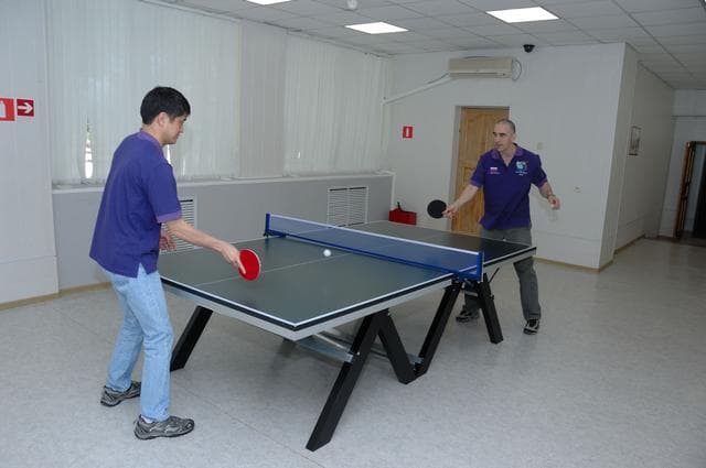 NASA image: At the Cosmonaut Hotel in Baikonur, Kazakhstan, Expedition 48-49 crewmembers Takuya Onishi of the Japan Aerospace Exploration Agency (left) and Anatoly Ivanishin of Roscosmos share a game of ping-pong June 30 during pre-launch activities. They and Kate Rubins of NASA will launch July 7, Baikonur time, on the Soyuz MS-01 spacecraft for a planned four-month mission on the International Space Station...NASA/Alexander Vysotsky.