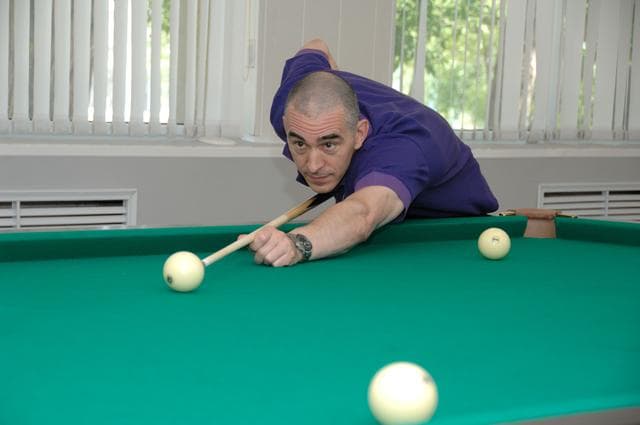 NASA image: At the Cosmonaut Hotel in Baikonur, Kazakhstan, Expedition 48-49 crewmember Anatoly Ivanishin of Roscosmos tries his hand a billiards June 30 during pre-launch activities. Ivanishin, Takuya Onishi of the Japan Aerospace Exploration Agency and Kate Rubins of NASA will launch July 7, Baikonur time, on the Soyuz MS-01 spacecraft for a planned four-month mission on the International Space Station...NASA/Alexander Vysotsky.