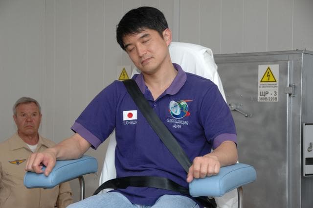 NASA image: At the Cosmonaut Hotel in Baikonur, Kazakhstan, Expedition 48-49 crewmember Takuya Onishi of the Japan Aerospace Exploration Agency takes a spin in a rotating chair to test his vestibular system June 30 as part of pre-launch activities. Onishi, Kate Rubins of NASA and Anatoly Ivanishin of Roscosmos will launch July 7, Baikonur time, on the Soyuz MS-01 spacecraft for a planned four-month mission on the International Space Station...NASA/Alexander Vysotsky.
