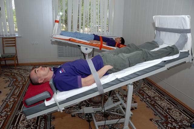 NASA image: At the Cosmonaut Hotel in Baikonur, Kazakhstan, Expedition 48-49 crewmembers Anatoly Ivanishin of Roscosmos (foreground) and Takuya Onishi of the Japan Aerospace Exploration Agency conduct tests of their vestibular system on tilt tables June 30 as part of pre-launch activities. They and Kate Rubins of NASA will launch July 7, Baikonur time, on the Soyuz MS-01 spacecraft for a planned four-month mission on the International Space Station...NASA/Alexander Vysotsky.