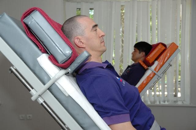 NASA image: At the Cosmonaut Hotel in Baikonur, Kazakhstan, Expedition 48-49 crewmembers Anatoly Ivanishin of Roscosmos (foreground) and Takuya Onishi of the Japan Aerospace Exploration Agency conduct tests of their vestibular system on tilt tables June 30 as part of pre-launch activities. They and Kate Rubins of NASA will launch July 7, Baikonur time, on the Soyuz MS-01 spacecraft for a planned four-month mission on the International Space Station...NASA/Alexander Vysotsky.