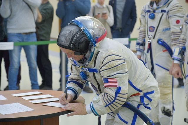 NASA image: jsc2017e135201 - At the Gagarin Cosmonaut Training Center in Star City, Russia, Expedition 54-55 prime crewmember Scott Tingle of NASA signs in for the start of the crew’s final qualification exam activities Nov. 29. Tingle, Anton Shkaplerov of the Russ