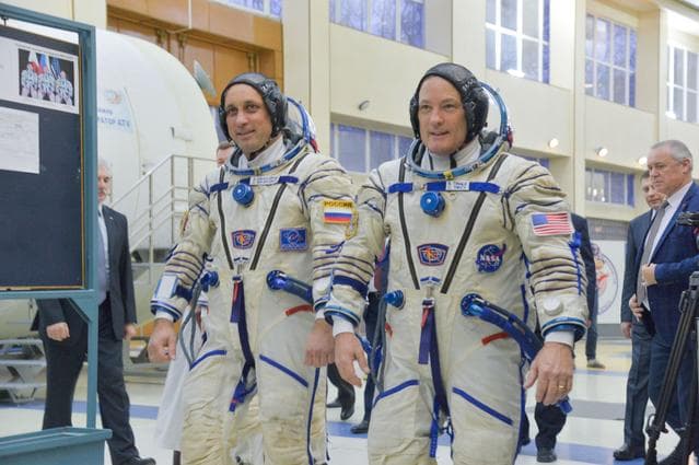 NASA image: jsc2017e135203 - At the Gagarin Cosmonaut Training Center in Star City, Russia, Expedition 54-55 prime crewmembers Anton Shkaplerov of the Russian Federal Space Agency (Roscosmos, left) and Scott Tingle of NASA (right) walk through a Soyuz spacecraft simu