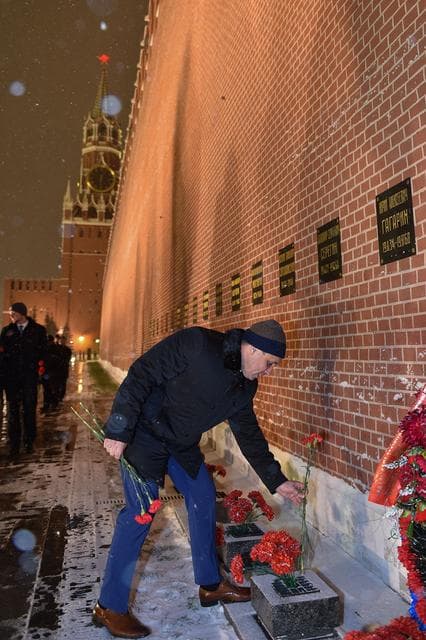 NASA image: jsc2017e136054 - On a snowy night at Red Square in Moscow, Expedition 54-55 crewmember Anton Shkaplerov of the Russian Federal Space Agency (Roscosmos) lays flowers at the Kremlin Wall where Russian space icons are interred in traditional pre-launch cerem