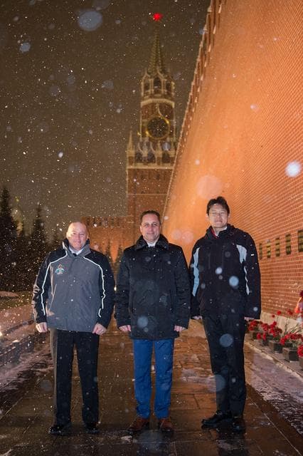 NASA image: jsc2017e136056 - On a snowy night at Red Square in Moscow, Expedition 54-55 crewmembers Scott Tingle of NASA (left), Anton Shkaplerov of the Russian Federal Space Agency (Roscosmos, center) and Norishige Kanai of the Japan Aerospace Exploration Agency (JA