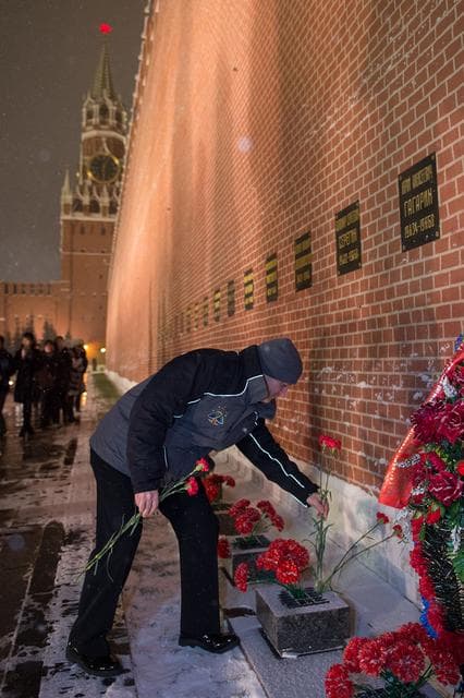 NASA image: jsc2017e136058 - On a snowy night at Red Square in Moscow, Expedition 54-55 crewmember Scott Tingle of NASA lays flowers at the Kremlin Wall where Russian space icons are interred in traditional pre-launch ceremonies Nov. 30. Tingle, Anton Shkaplerov of t