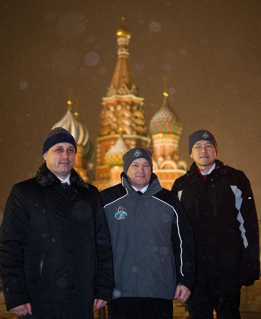 NASA image: jsc2017e136059 - On a snowy night at Red Square in Moscow, Expedition 54-55 crewmembers Anton Shkaplerov of the Russian Federal Space Agency (Roscosmos, left), Scott Tingle of NASA (center) and Norishige Kanai of the Japan Aerospace Exploration Agency (JA