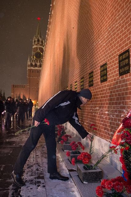 NASA image: jsc2017e136060 - On a snowy night at Red Square in Moscow, Expedition 54-55 crewmember Norishige Kanai of the Japan Aerospace Exploration Agency (JAXA) lays flowers at the Kremlin Wall where Russian space icons are interred in traditional pre-launch cerem