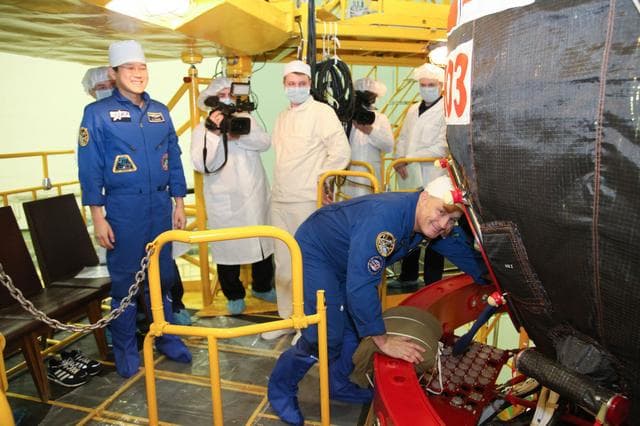 NASA image: jsc2017e136446 - In the Integration Facility at the Baikonur Cosmodrome in Kazakhstan, Expedition 54-55 crewmember Scott Tingle of NASA (right) boards the Soyuz MS-07 spacecraft Dec. 5 as part of the first fit check dress rehearsal activities while crewma